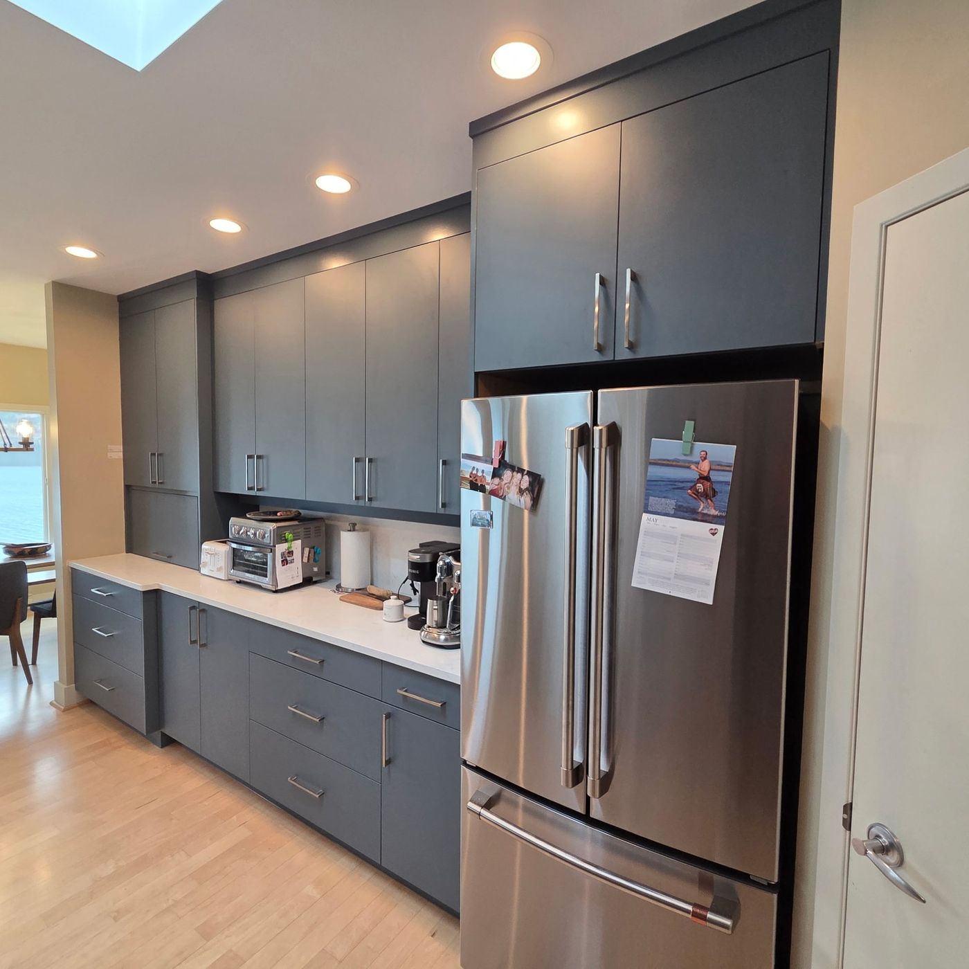 Kelowna kitchen refaced in dark slate cabinets with a lake view
